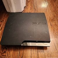 Top view of PS3 Slim console showing matte finish and logo