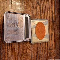 Closed view of both cigarette holders showing exterior designs