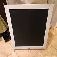 Front view of framed chalkboard panel with latch and mounting hooks
