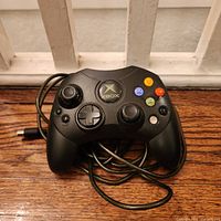 Front view of black Microsoft Xbox Controller S showing buttons, sticks and cord