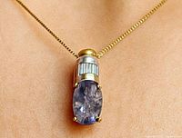 Pendant worn on chain showing overall design and colour