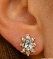 earring worn on ear showing size and design