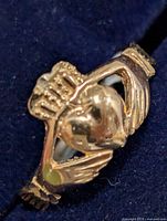 Front view showing Claddagh heart, hands and crown detail