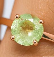 Close-up of tourmaline and prongs on finger