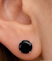 earring worn in ear displaying size and black gemstone