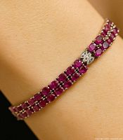 Ruby double-row silver bracelet worn on wrist