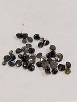 Group shot of all loose black diamonds on white background