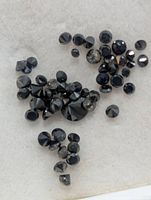 Close-up of mixed size black diamonds