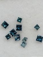 Close-up of blue diamonds showing square princess cuts