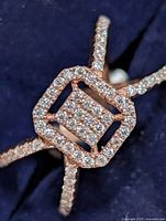 Front view of ring showing square halo and pavé split shank