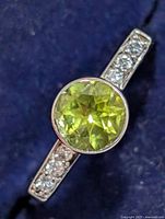 Front view showing peridot centre stone and CZ shoulders
