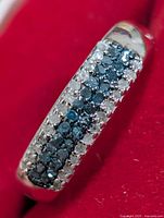 Top view showing pavé blue and white diamonds on the band