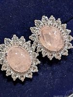 front view of both earrings showing rose quartz centers and surrounding clear stones