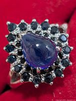 Front view of ring showing pear sapphire and halo