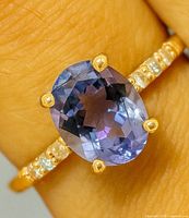 Ring on finger showing tanzanite and prongs