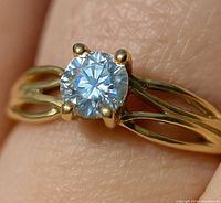 Close-up of diamond in four-prong setting on split shank band