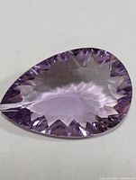Close-up of pear-cut amethyst face showing color and faceting