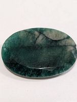 Top view of oval emerald gemstone showing color and inclusions