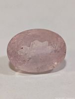 Front view of faceted oval pale pink morganite gemstone showing table and inclusions
