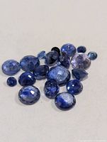 Group of loose blue sapphires showing various cuts and sizes