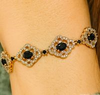 Bracelet worn on wrist showing link design and stones