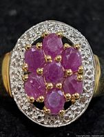 Top view of ruby cluster ring highlighting gemstones and halo