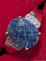 front view showing oval blue sapphire and side accent stones