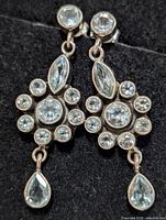 Front view of both earrings showing blue topaz stones and drop design