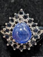 Front view showing pear cabochon sapphire and surrounding stones