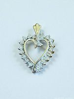 Front view of 10k gold heart pendant with diamond halo