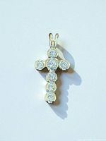 Front view of gold diamond cross pendant