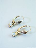 Pair of gold lever-back earrings with diamond drops