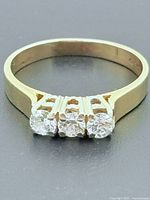 Top view of 14k gold trinity ring showing three diamonds