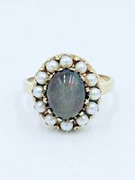 top view of ring showing black opal and pearl halo