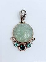 Front view of pendant showing stones and silver detailing