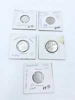Front view of five coins in labeled flips