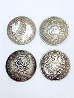 Obverse designs of all four coins showing national emblems and dates