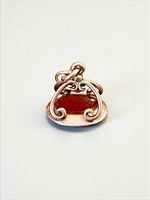 Front view of gold fob showing carnelian seal and scroll frame