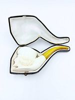 Pipe in open fitted case showing interior lining and overall form