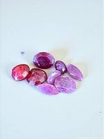 Group of nine rose-cut rubies showing shapes and colour