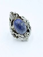 Front view showing lapis cabochon and floral gallery