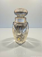 Full view of crystal decanter with sterling rim and stopper