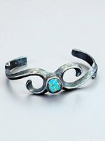 Full view of sterling silver cuff showing turquoise stone and scroll design