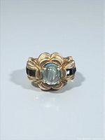 Front view of sterling silver ring showing light blue sapphire center and dark blue shoulder stones