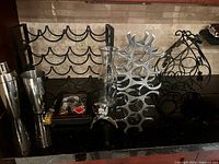 Overview of wine racks, shaker, decanter, bar tool set on countertop