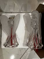 Two clear crystal angel figurines on styrofoam insert