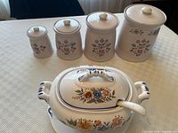 Full set showing soup tureen in front of four canisters