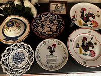 Group shot of all ceramic pieces, tile, figurine and flowers