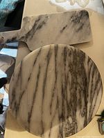 Top view of round lazy susan and rectangular paddle board