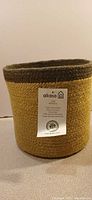 Smaller Alkaso jute basket with tag, showing weave and color